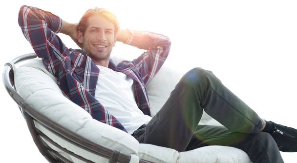 close-up. a successful guy sitting in a large round comfortable  - Foto, Imagem