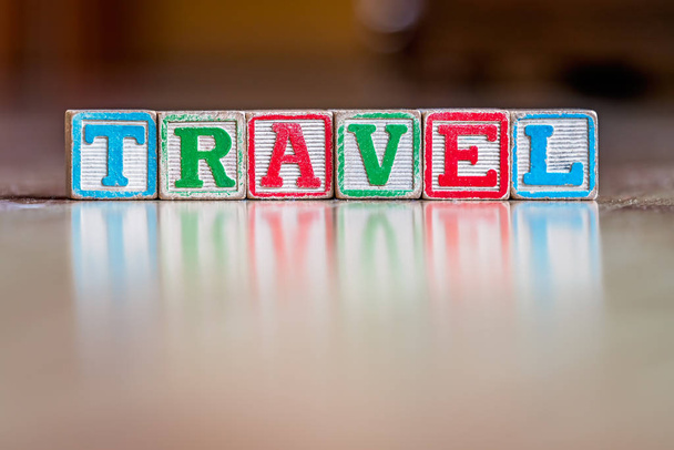 Toy letter blocks spelling the word travel - Foto, afbeelding