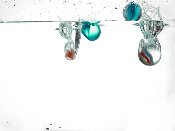marbles dropped in water - Photo, Image