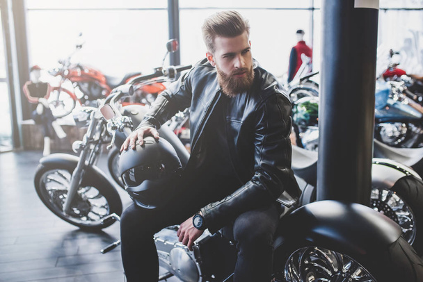Man in motorcycle shop - 写真・画像