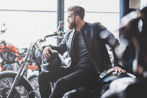 Man in motorcycle shop - Photo, image