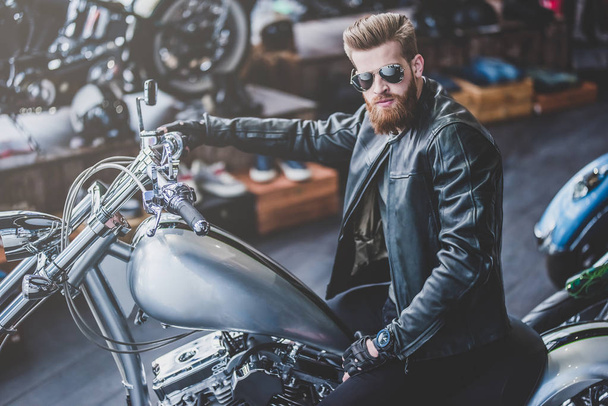 Man in motorcycle shop - Photo, image