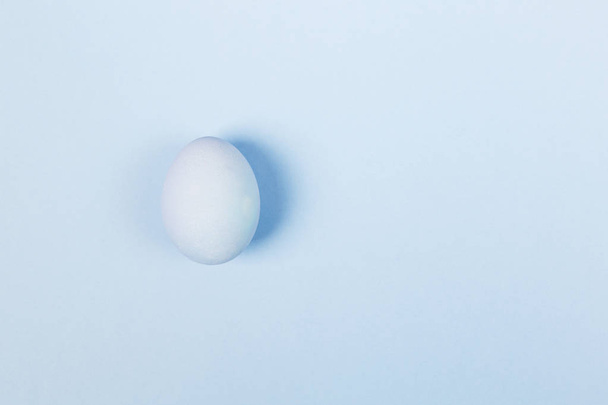 Blue egg on blue background. Top view, copy space. Food backgrou - Фото, изображение