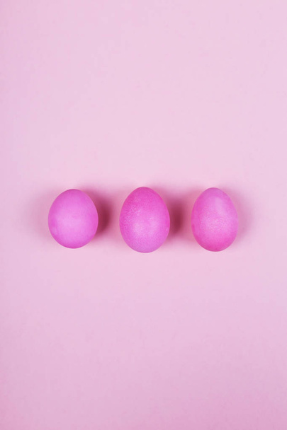 Pink eggs on pink background. Top view - Zdjęcie, obraz