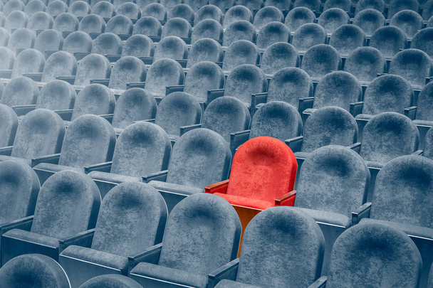 Un rouge parmi les gris dans les rangées de sièges dans la salle de cinéma. Vue depuis les escaliers sur des rangées de chaises confortables dans le théâtre ou le cinéma
.  - Photo, image