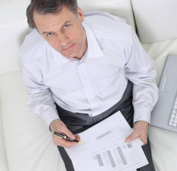 view from the top.businessman working with documents sitting on sofa - Photo, image