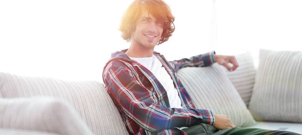 handsome successful guy sitting on the couch. - Photo, Image