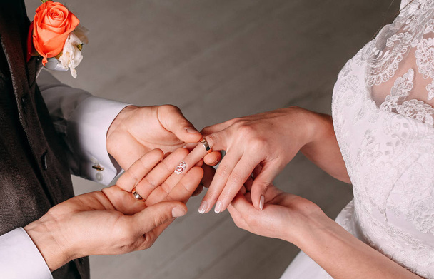Wedding ceremony bride groom putting golden rings  - Фото, зображення