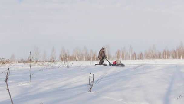 Mann in Winterkleidung rast und manövriert auf Mini-Schneemobil durch tiefe Schneeverwehungen - Foto, Bild