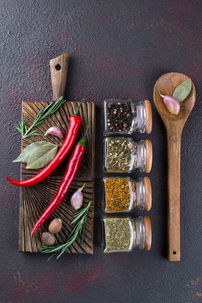 Group of spices and herbs  on dark background with top view and copy space for design - Fotó, kép