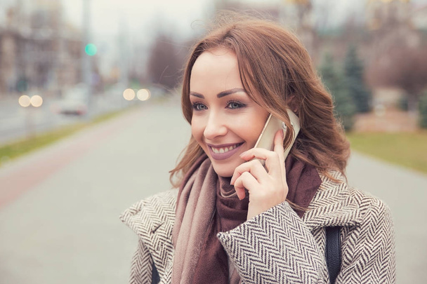 Content woman having phone call on street - Fotografie, Obrázek
