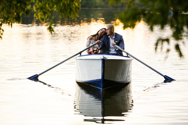 young couple hugging and kissing boating - Foto, Imagem
