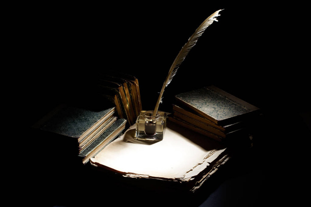 Old fountain pen, papers and inkwell on a black background - Photo, image