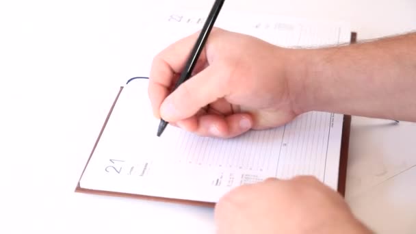 Man writing information in business agenda book - Footage, Video