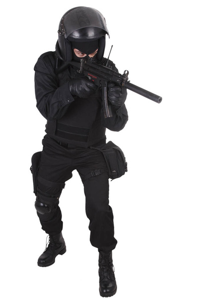 police special forces officer with submachine gun in black uniform isolated on white - Fotó, kép