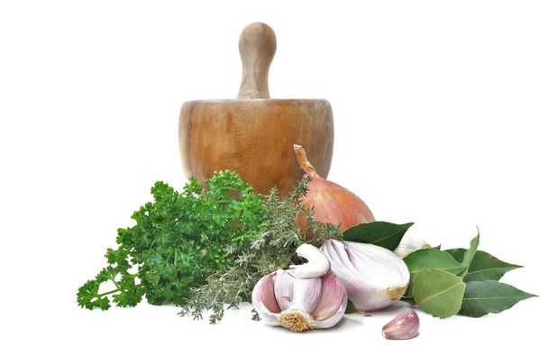 Herbs and onions garlic with a wooden pestle - Photo, Image