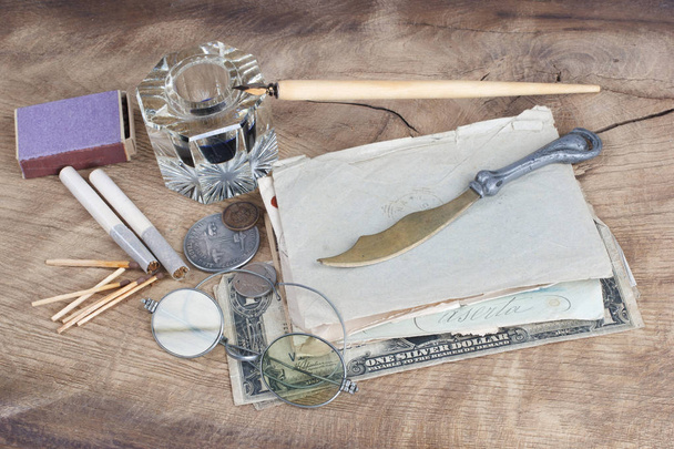 Old fountain pen and inkwell with old letters on a wooden background - Photo, Image