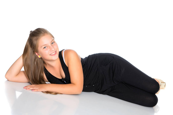 A teenage girl lies on the floor - Fotó, kép