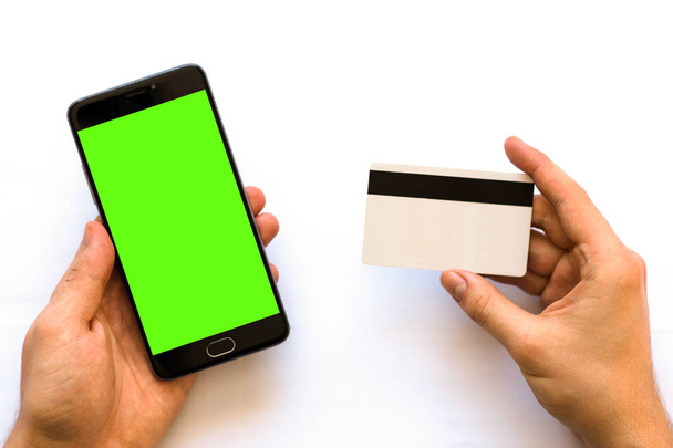 green screen for chroma key compositing Smartphone with Online payments plastic card. Horizontal mockup. - Photo, Image
