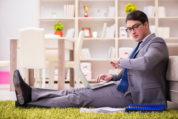 Businessman working on the floor at home - Photo, Image