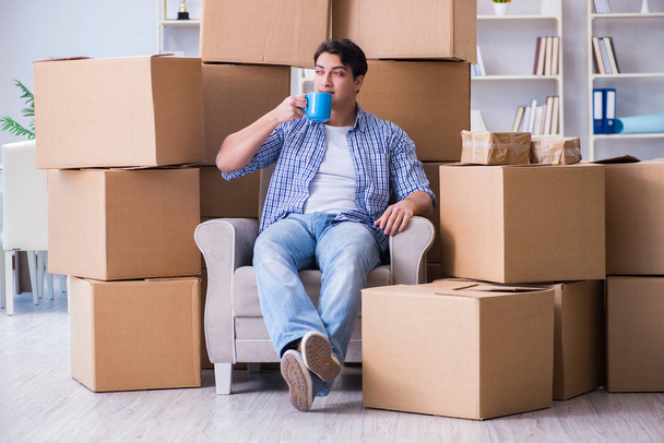 Young man moving in to new house with boxes - Photo, Image
