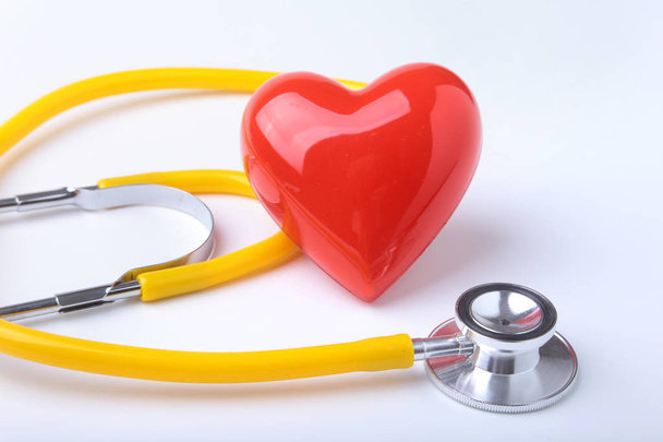 Red heart and a stethoscope on white background - Photo, image