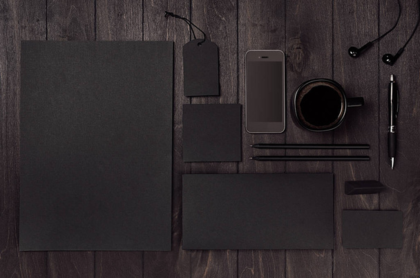 Dark deluxe black branding stationery, mockup scene with phone, coffee on black wooden plank, blank objects for placing your design. Modern stylish male work place. - Fotografie, Obrázek