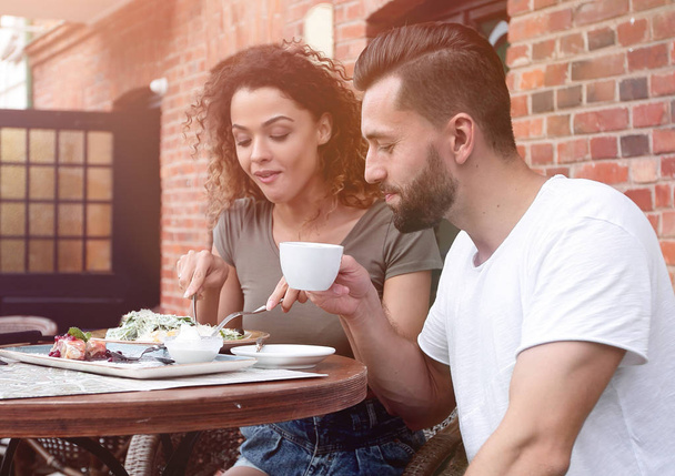 Portrait of lovely romantic couple sitting in a cafe with coffee - Foto, Imagen