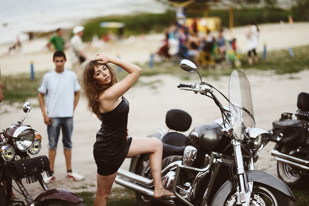 Young attractive girl and motorcycle - Фото, изображение