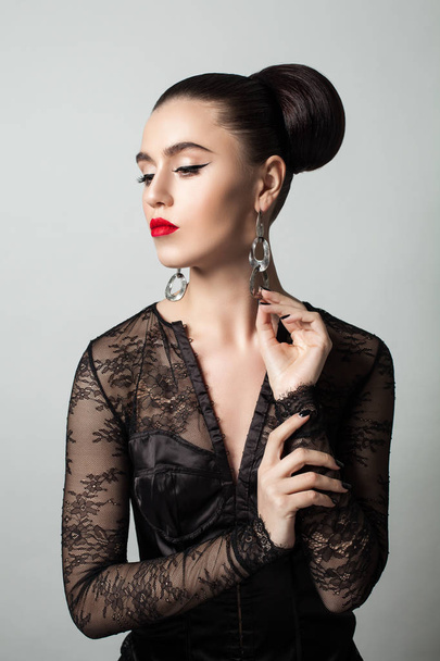 Stylish Woman with Makeup and Perfect Hairstyle - 写真・画像