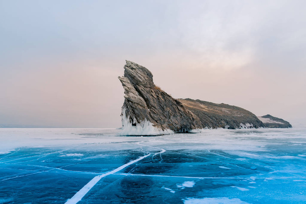 Ogoy rock over frozen water lake Baikal Russia winter season natural landscape  - Fotó, kép