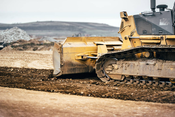 highway construction site development with bulldozer moving earth, soil and leveling ground - Foto, Bild