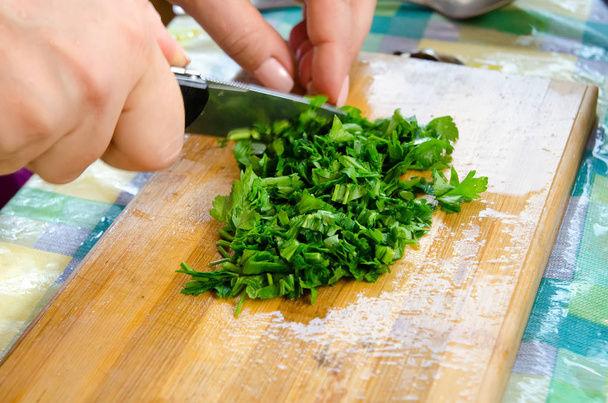 the cook cuts parsley with a knife - Photo, Image