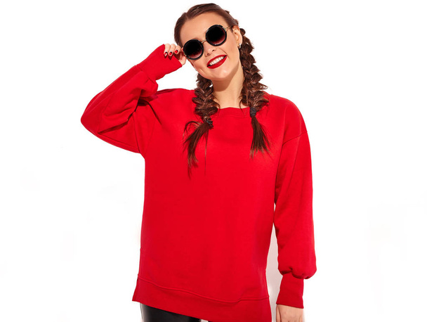 Portrait of young happy smiling woman model with bright makeup and colorful lips with two horns and sunglasses in summer red clothes isolated on white. Going crazy - Photo, Image