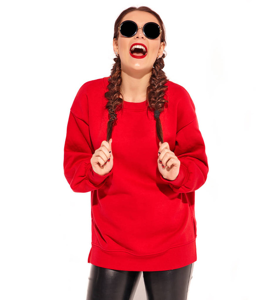 Portrait of young happy smiling woman model with bright makeup and colorful lips with two horns and sunglasses in summer red clothes isolated on white. Going crazy - Foto, Imagem