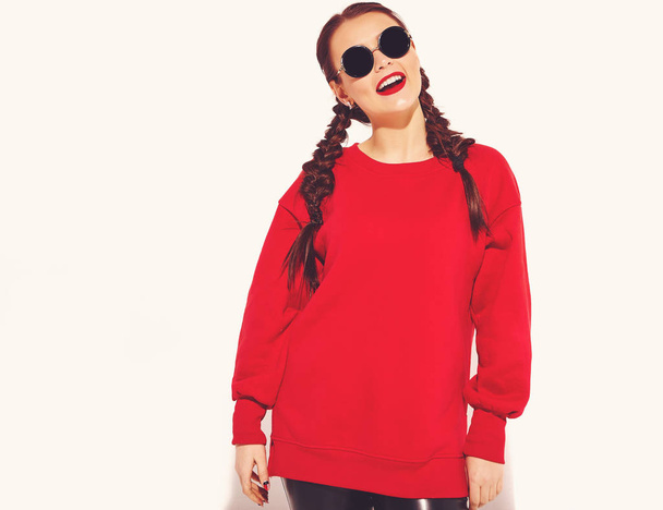 Portrait of young happy smiling woman model with bright makeup and colorful lips with two horns and sunglasses in summer red clothes isolated on white. Going crazy - Fotoğraf, Görsel