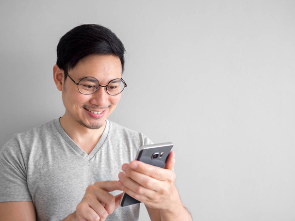 Happy man is using smartphone. Concept of using social media on  - Foto, imagen