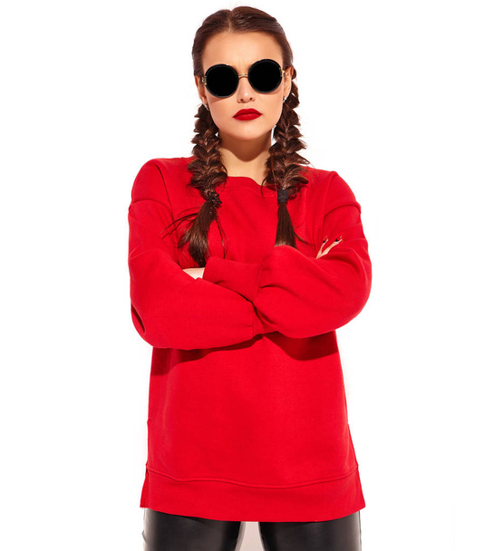 Portrait of young happy smiling woman model with bright makeup and colorful lips with two horns and sunglasses in summer red clothes isolated on white. crossed arms - Foto, afbeelding