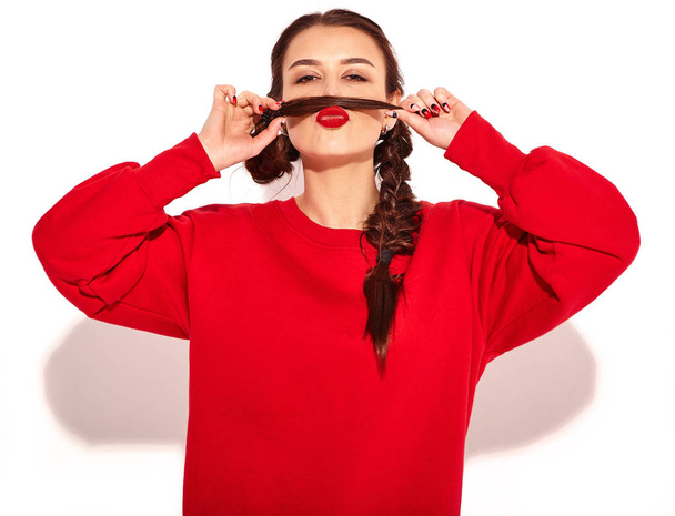 Portrait of young happy smiling woman model with bright makeup and colorful lips with two horns and sunglasses in summer red clothes isolated on white. Making mock moustache using her own hair - Foto, immagini