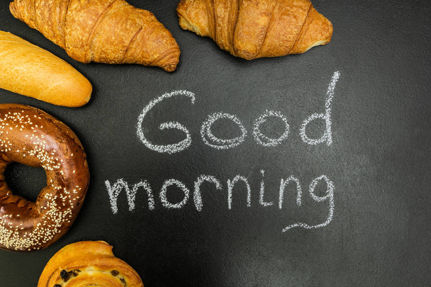 Fresh buns on a black background, the words "good morning" - Fotografie, Obrázek
