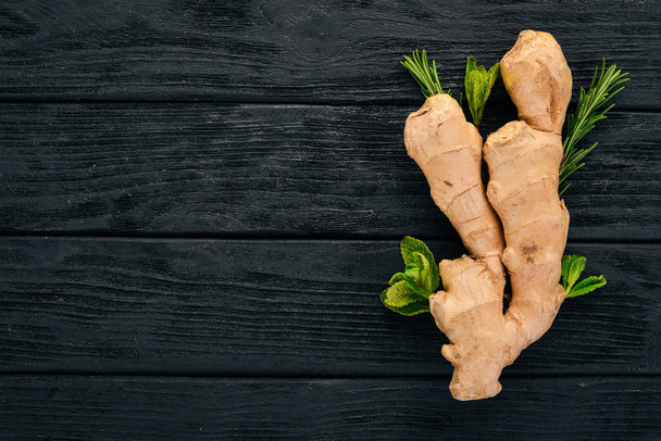 Fresh ginger on a wooden background. Top view. Copy space. - Fotografie, Obrázek