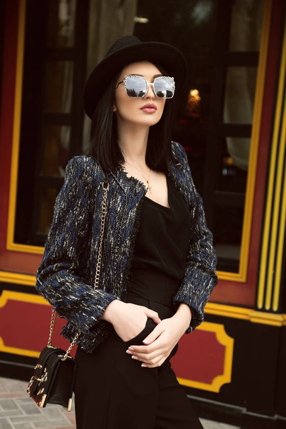 beautiful girl with dark hair in elegant clothes walking by the  - Valokuva, kuva