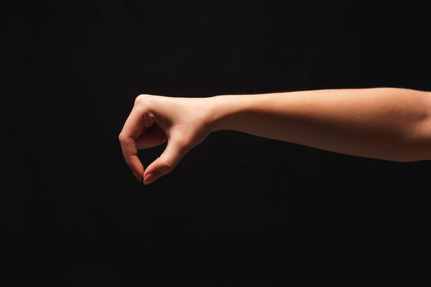 La mano femenina recogiendo algo, recorte en negro
 - Foto, Imagen