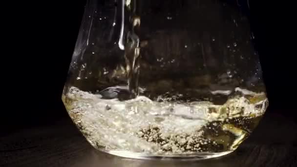 White wine is poured into the decanter - Кадри, відео