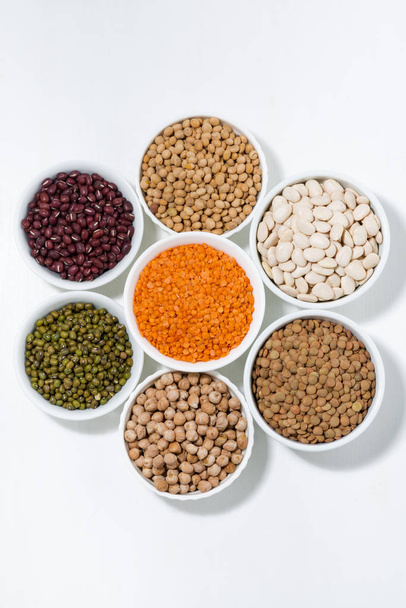 assortment of legumes in bowls, top view vertical - Photo, Image