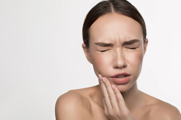 Female is suffering from toothache - 写真・画像