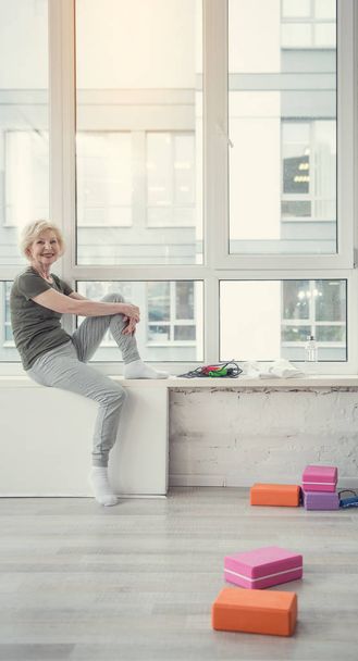 Glad mature woman relaxing at gym - Photo, Image