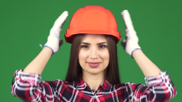 Giyen hardhat gülümseyen bir seksi güzel kadın constructionist yakın çekim - Video, Çekim