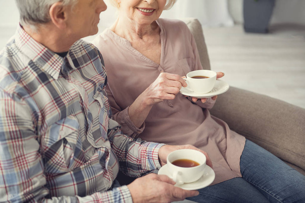 Old wife and husband enjoying morning beverage - Фото, изображение