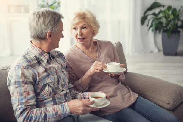 Mature people chatting while drinking tea - Fotó, kép